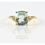Aquamarine and diamond ring; central oval faceted aquamarine flanked either side by three round