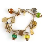 Vintage fancy link gold charm bracelet with fifteen charms, including four jugs, a typewriter,