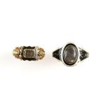 Two antique mourning rings, a Georgian ring with central oval glazed hairwork panel, black and white