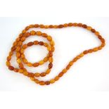 1920's amber opera length necklace, of light to deep orange beads, length 95 cm. CONDITIONweight