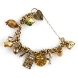 Gold charm bracelet, curb links with heart padlock clasp, hallmarked 9 ct, with fourteen charms,