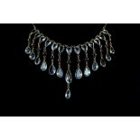 Aquamarine and sapphire fringe necklace, set with twenty one pear form stones and cabochon round