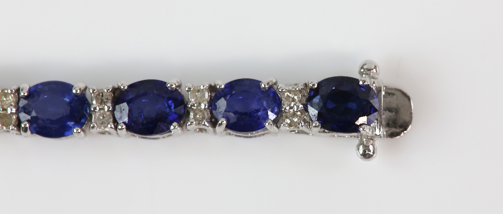 Sapphire diamond line bracelet; twenty-six oval faceted sapphires are four-claw set and alternated - Image 6 of 8