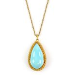 Gold pendant set with large pear form turquoise stone, flowerhead mount, on a rope twist chain