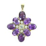 Large modern cross pendant, set with eight oval cut amethysts and five round cut white sapphires,