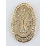 Diamond set pendant, in oval form with central floral motif, set with round brilliant cut