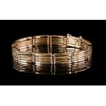 Gold gate bracelet, links made up of five bars, concealed clasp and safety chain, stamped 9 ct, 18cm