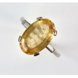 Dress ring set with oval yellow topaz estimated at 5.00 carats and baguette diamond shoulders,