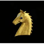 Cartier horse head brooch, gold with textured finish, set with sapphire and diamond, signed and