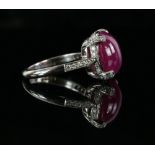 Ruby and diamond ring, with an oval cabochon cut stone, in platinum mount set with diamonds, ruby