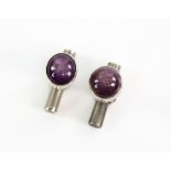 A pair of cufflinks set with star rubies in unmarked white metal . CONDITION