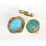 Two turquoise rings, one oval cabochon cut in a filigree mount, ring size M another rough cut in