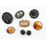 A group of antique jewellery, Pietra dura floral brooch in white metal mount, carved jet portrait