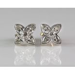Boodles diamond 'Flower Press' design earrings in the form of two star form flower heads, the petals