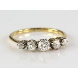 Edwardian ring set with five old cut diamonds, centre stone estimated as 0.30 carat, claw setting,in