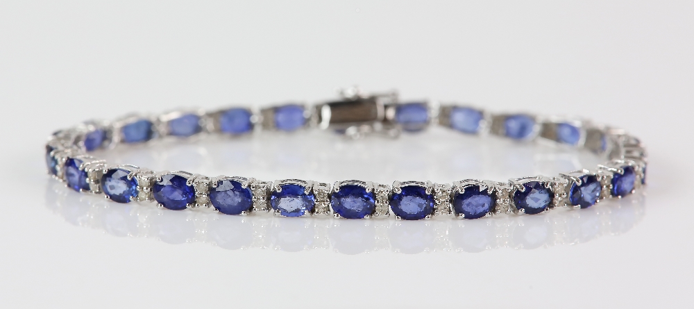 Sapphire diamond line bracelet; twenty-six oval faceted sapphires are four-claw set and alternated - Image 2 of 8