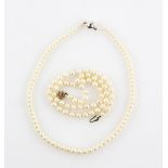 Two cultured pearl necklaces, one with cream coloured baroque shaped pearls, strung with knots