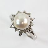 Pearl diamond dress ring, central white pearl, 9mm in diameter, set in a frame of Swiss cut