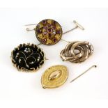 Four Victorian brooches, one with seed pearl floral motif on the black enamel, with hair in