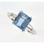 Aquamarine ring with tapering baguette cut diamond shoulders, the stepped cut aquamarine stone