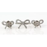 Tiffany & Co diamond bow earrings and matching ring, size M, set in platinum, signed and boxed.