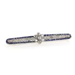 Art Deco bar brooch, the central daisy set with old cut diamonds, further diamonds in millegrain