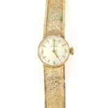 Omega, a Ladies Reference 1061 gold wristwatch, the signed silvered dial with baton hour markers ,
