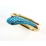 Antique snake bangle set with turquoise stones, with cabochon garnet eyes, two sprung hinged