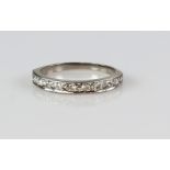 Half eternity diamond ring, set with eleven Swiss cut diamonds, mount testing as 18 ct, ring size N.