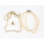 A pearl necklace with white gold openwork clasp, 9 ct, length 39 cm, another similar with barrel