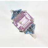 Vintage dress ring set with an emerald cut pink Kunzite stone bordered by two aquamarine stones in