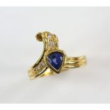 Pear cut sapphire ring accented with four diamonds, 18 ct yellow gold shank, ring size N.