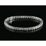 Diamond line bracelet; forty-six round cut diamonds in a rubover, hexagonal settings, estimated