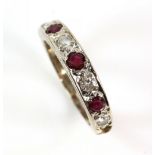 Mid 20th C ruby and diamond half eternity ring, white gold mount stamped 18 ct, ring size K 1/2