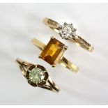 Three gold rings, a citrine ring, in 18 ct gold, an illusion set diamond ring, another with green