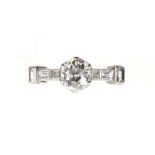 Early 20th C diamond ring, set with an old cut diamond and baguette cut diamond shoulders, centre