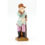 19th century porcelain figurine of a male clothed in a brown hat, black boots and green tunic with