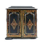 19th century black lacquered, gilt and red decorated sewing box, the hinged cover decorated with a