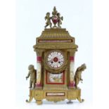 19th century French gilt metal mantel clock inset with red ground porcelain plaques decorated with