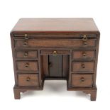 Early 20th century mahogany miniature kneehole desk with brushing side long drawer and seven other
