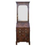 18th century walnut bureau cabinet with mirrored door, with herringbone cross-banding, the bureau