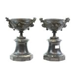 Pair of 19th Century bronze urns on polished slate bases - 23 cm high . .