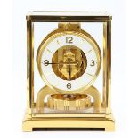 Jaeger-LeCoultre 'Atmos' clock, with a brass case with five glazed panels and a white circular dial,