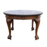 Early 20th Century mahogany extending dining table with three extra leaves raised on cabriole legs