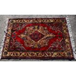Persian red ground rug with single central medallion, and multiple borders, 223cm x 142cm,. .