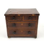 19th century miniature mahogany chest of two short and two long drawers, 19cm x 23cm . .
