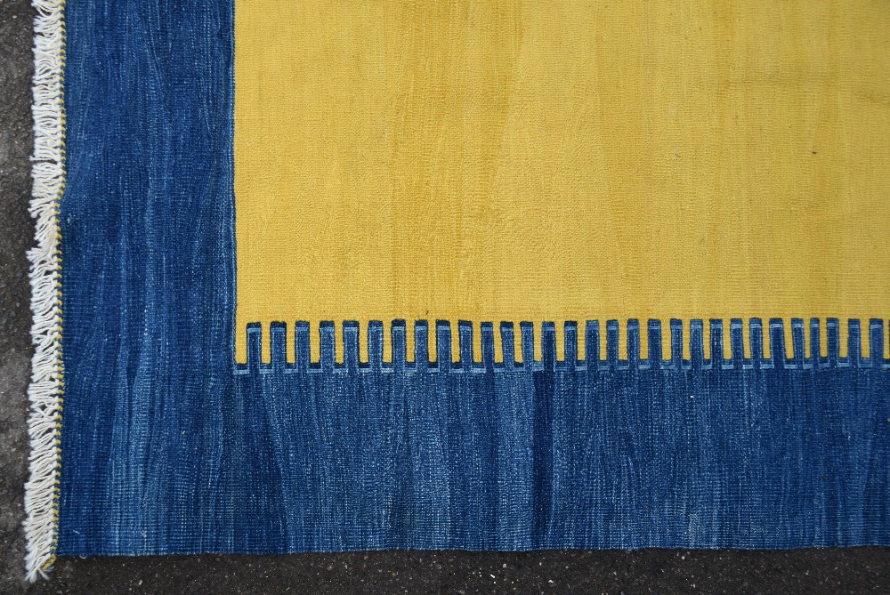 Modern yellow ground rug with a blue border,. . - Image 2 of 3