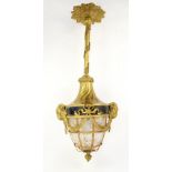 Early 20th century gilt metal hall lantern mounted with goats masks and a crackled ice glass shade