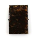 19th century plain tortoiseshell card case on X frame support, 11 x 7.5 cms. .