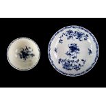 First period Worcester teabowl and saucer in underglaze blue floral pattern over feather moulding,